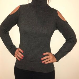 Dark Grey turtle neck, with open shoulder detail.